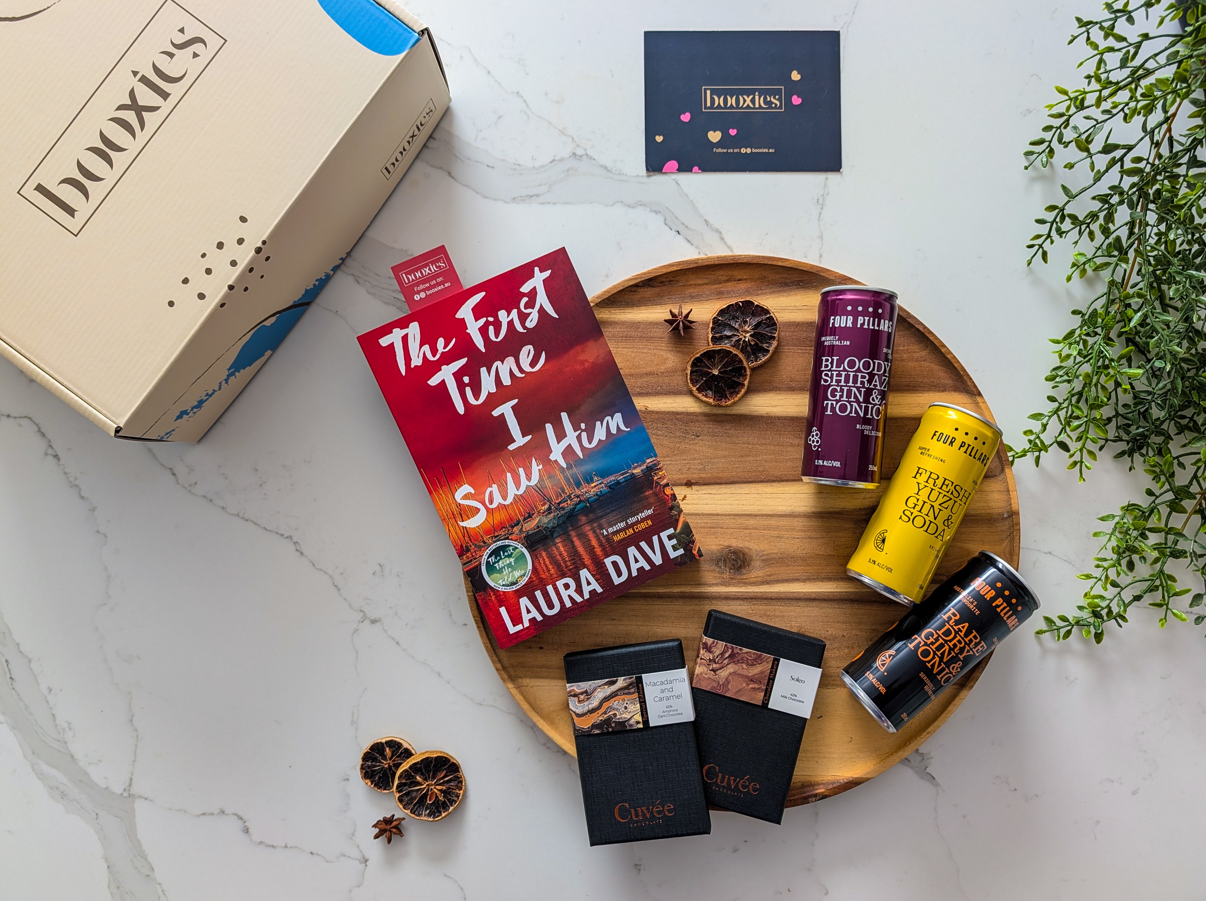 the first time i saw him book on a wooden tray with 2 hand made chocolate from Cuvee and 3x g&T from Four Pilars and a booxies box making G&T Trio n Tale Curated Booxies