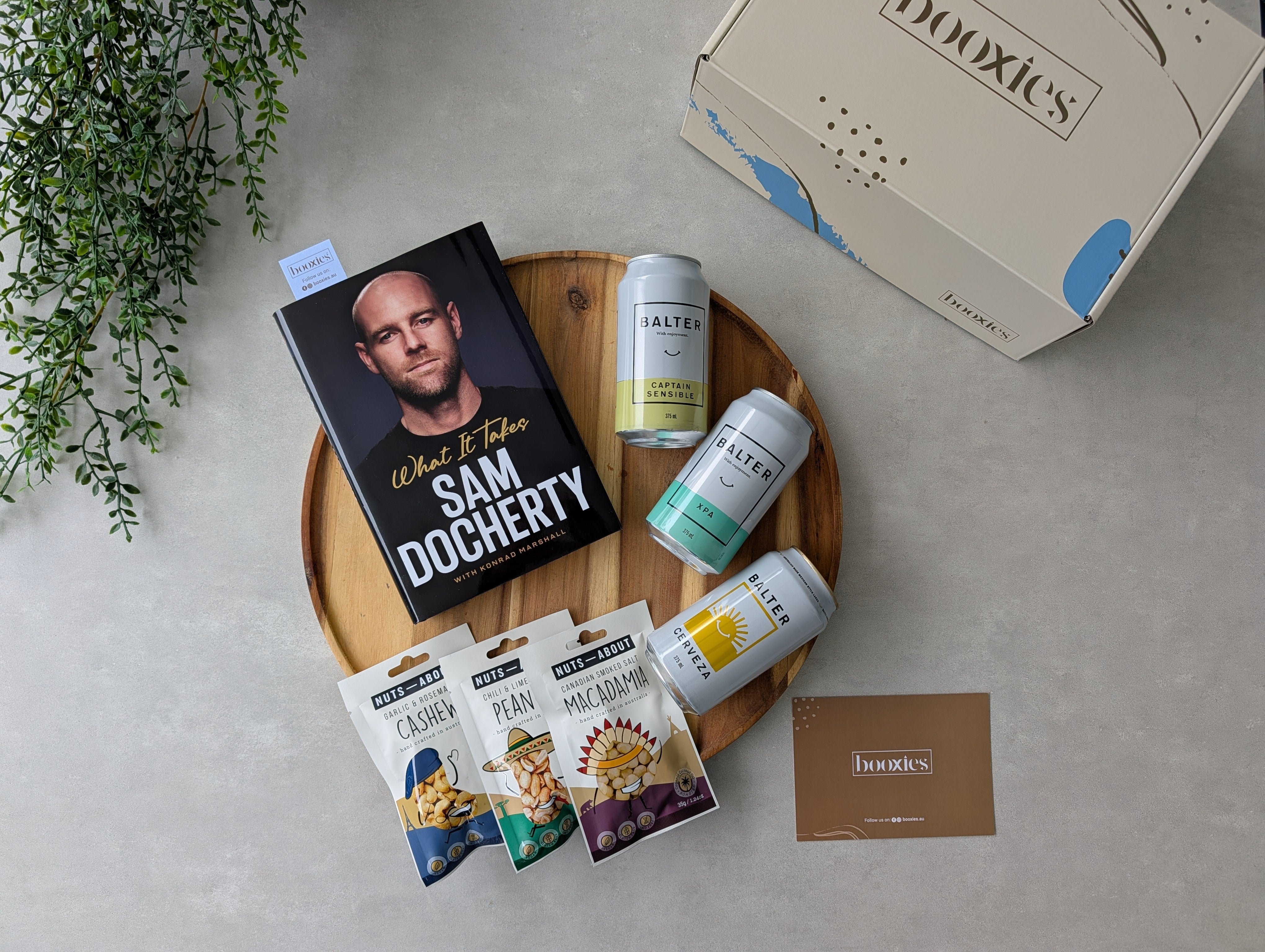 happy hours crafted beer and roasted nuts and books gift box on a flatlay