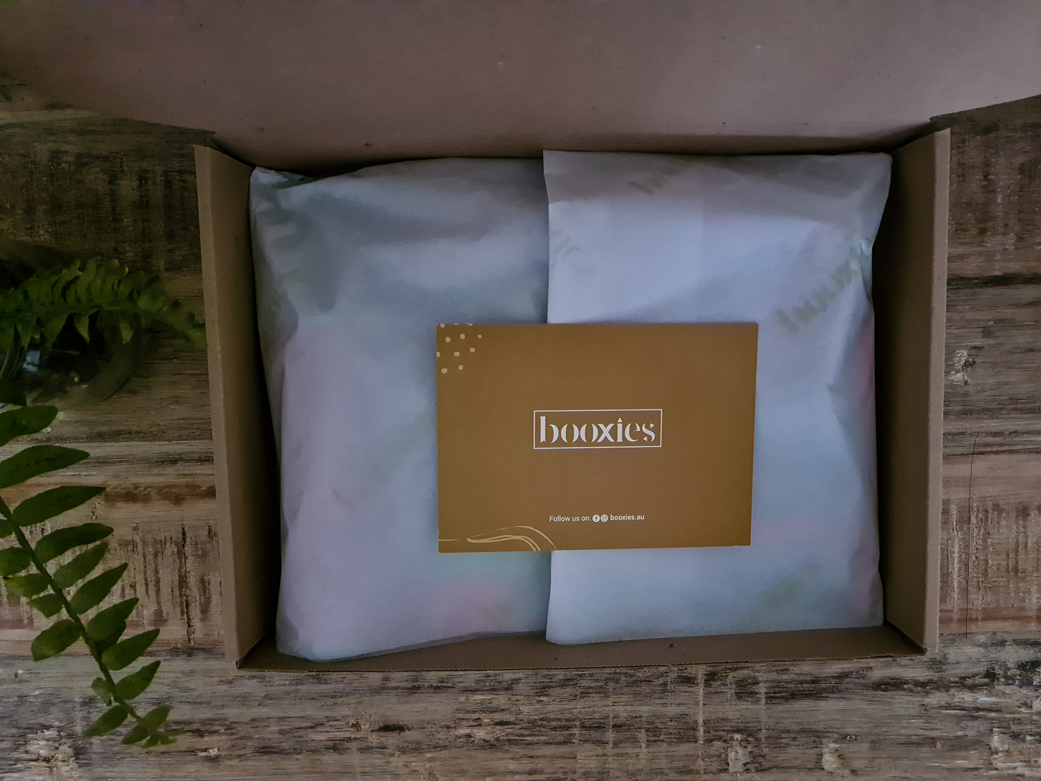 booxies book subscription box opened showing greeting card and tissue paper