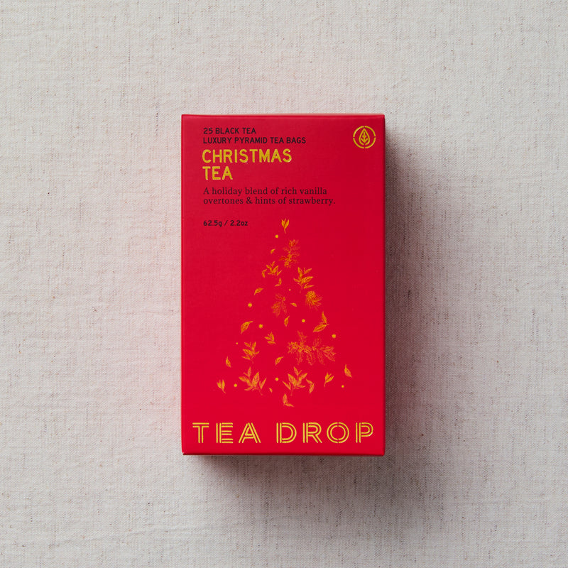 Red box of Tea Drop Christmas Tea on a light gray background