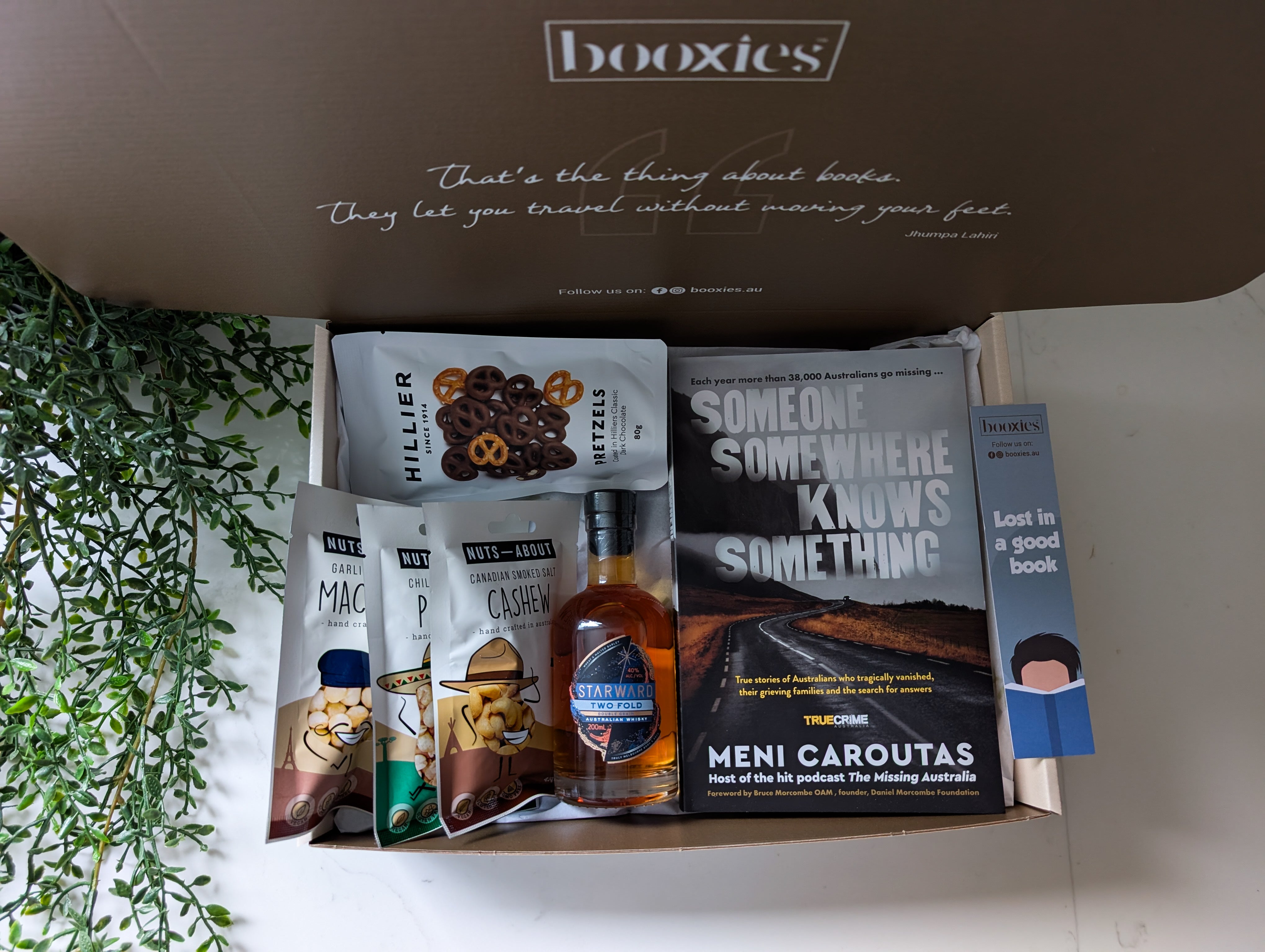 Booxies curated father's day gift box with books and snacks on a white surface