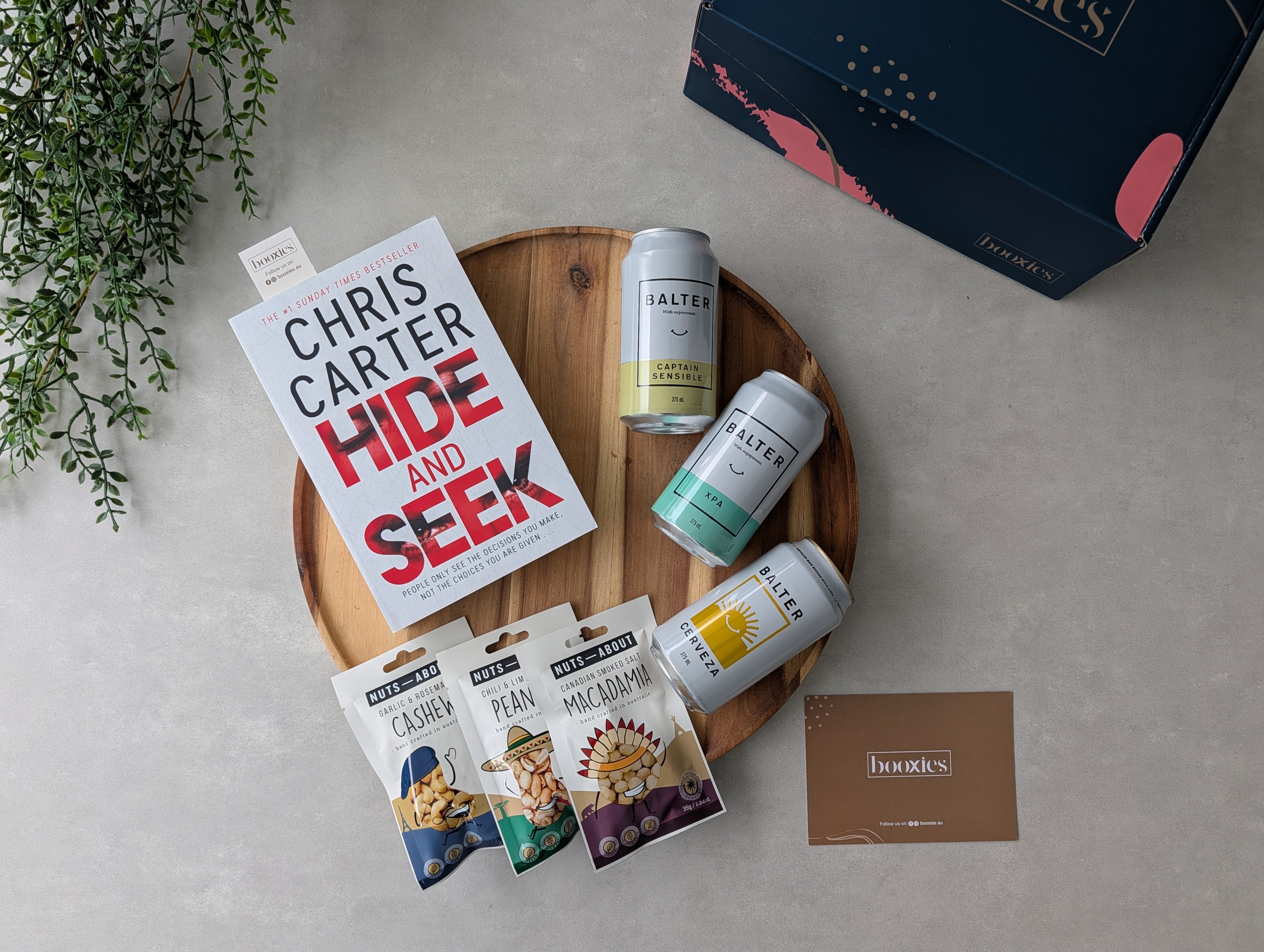 happy hours crafted beer and roasted nuts and books gift box on a flatlay