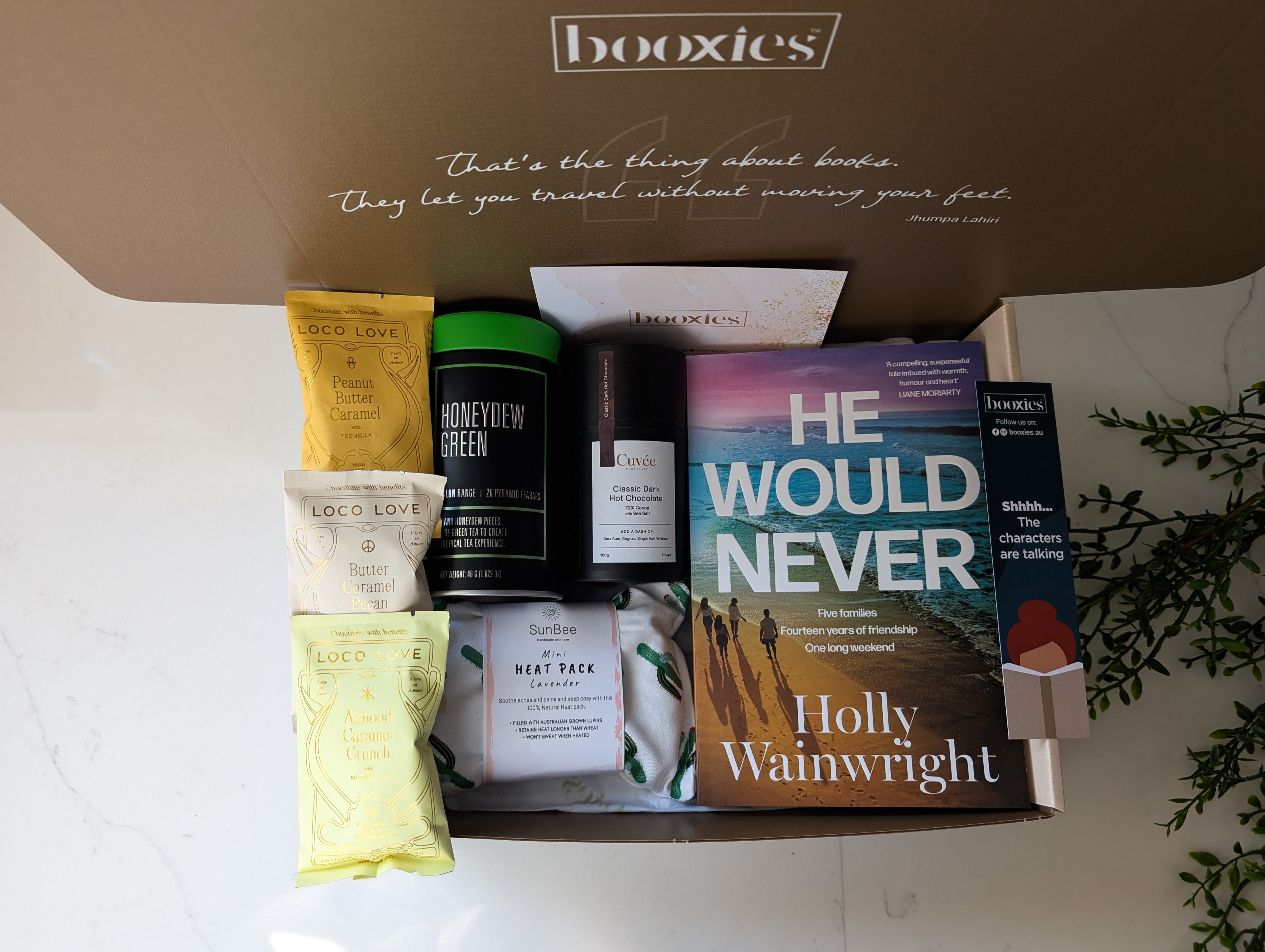 a warm hug booxies gift box including a book from your favourite genre, tea, hot chocolate or chai hot chocolcate, 3x vegan organic chocolate, lavendar heat pack, a bookmark and greeting card