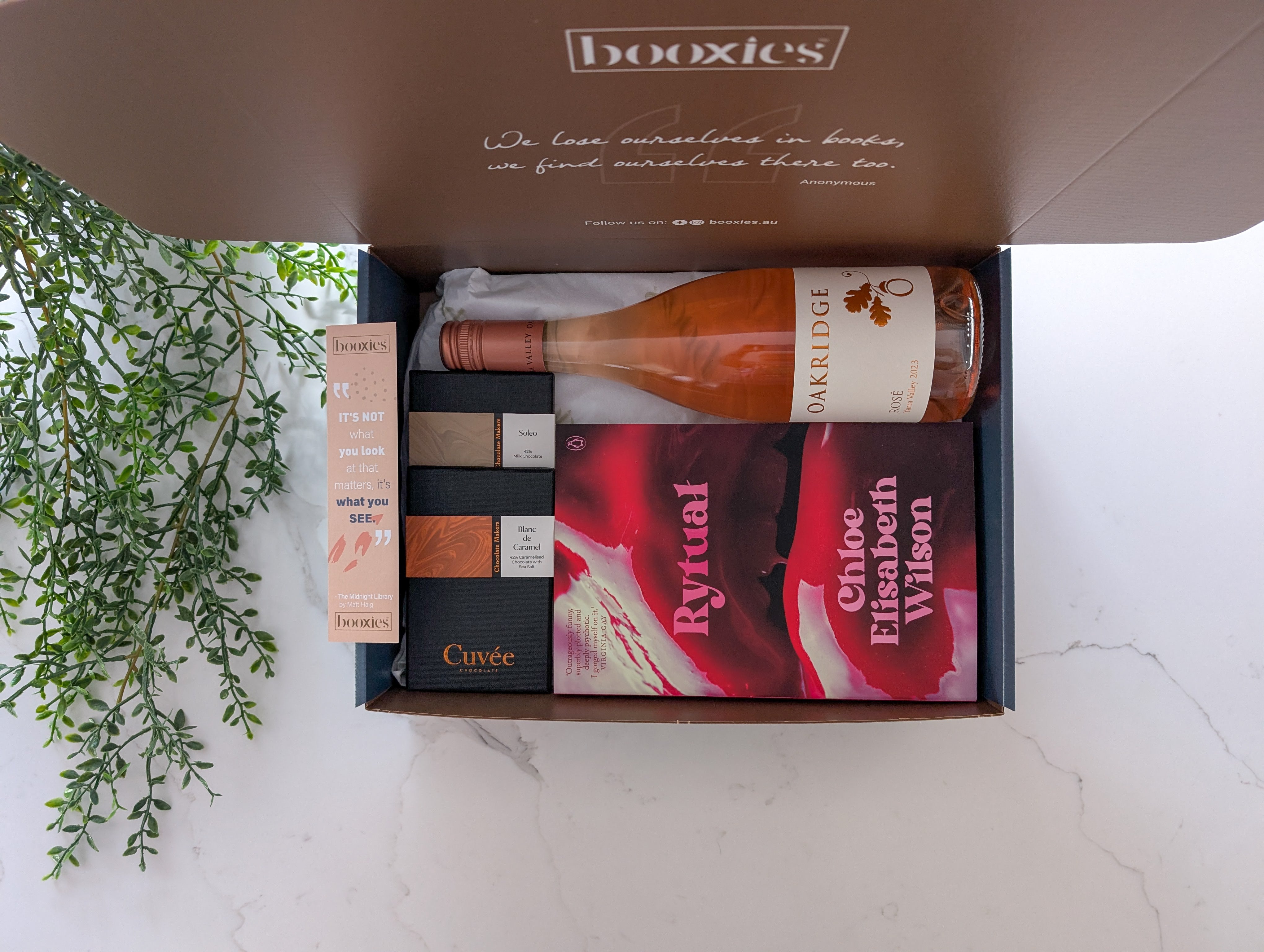 read n wine gift box with a book from your preferred genre and abottle of wine paired with hand made chocolate