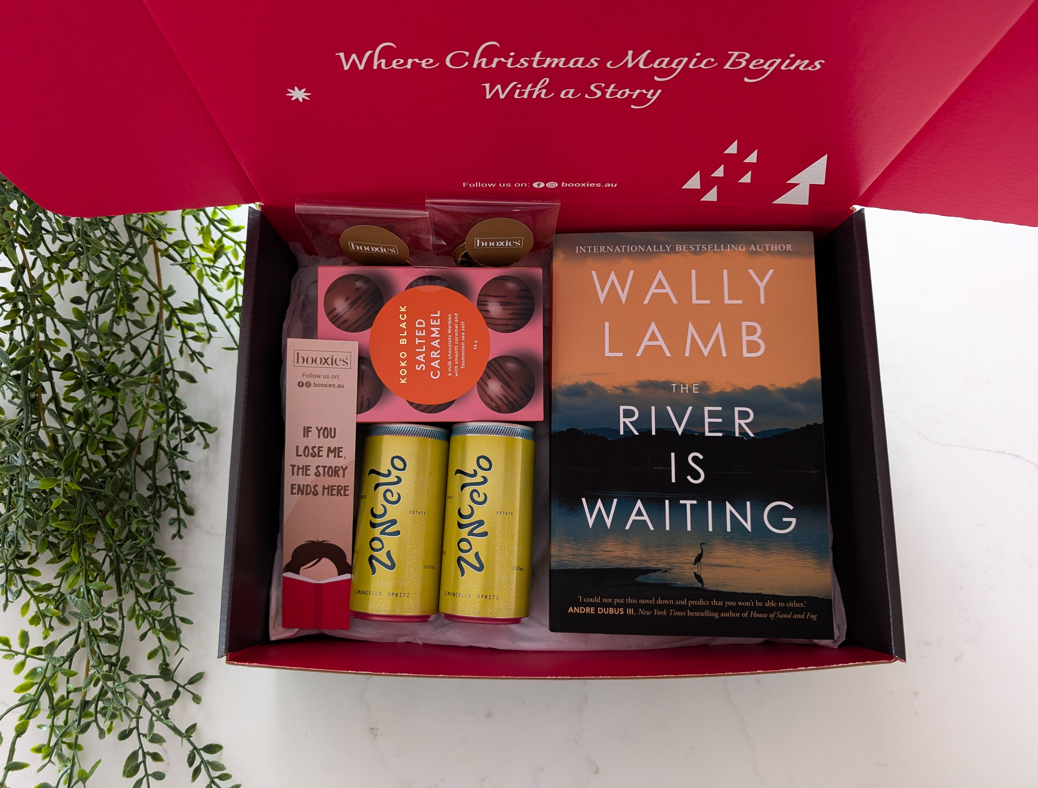 Gift box with a book and snacks on a white background
