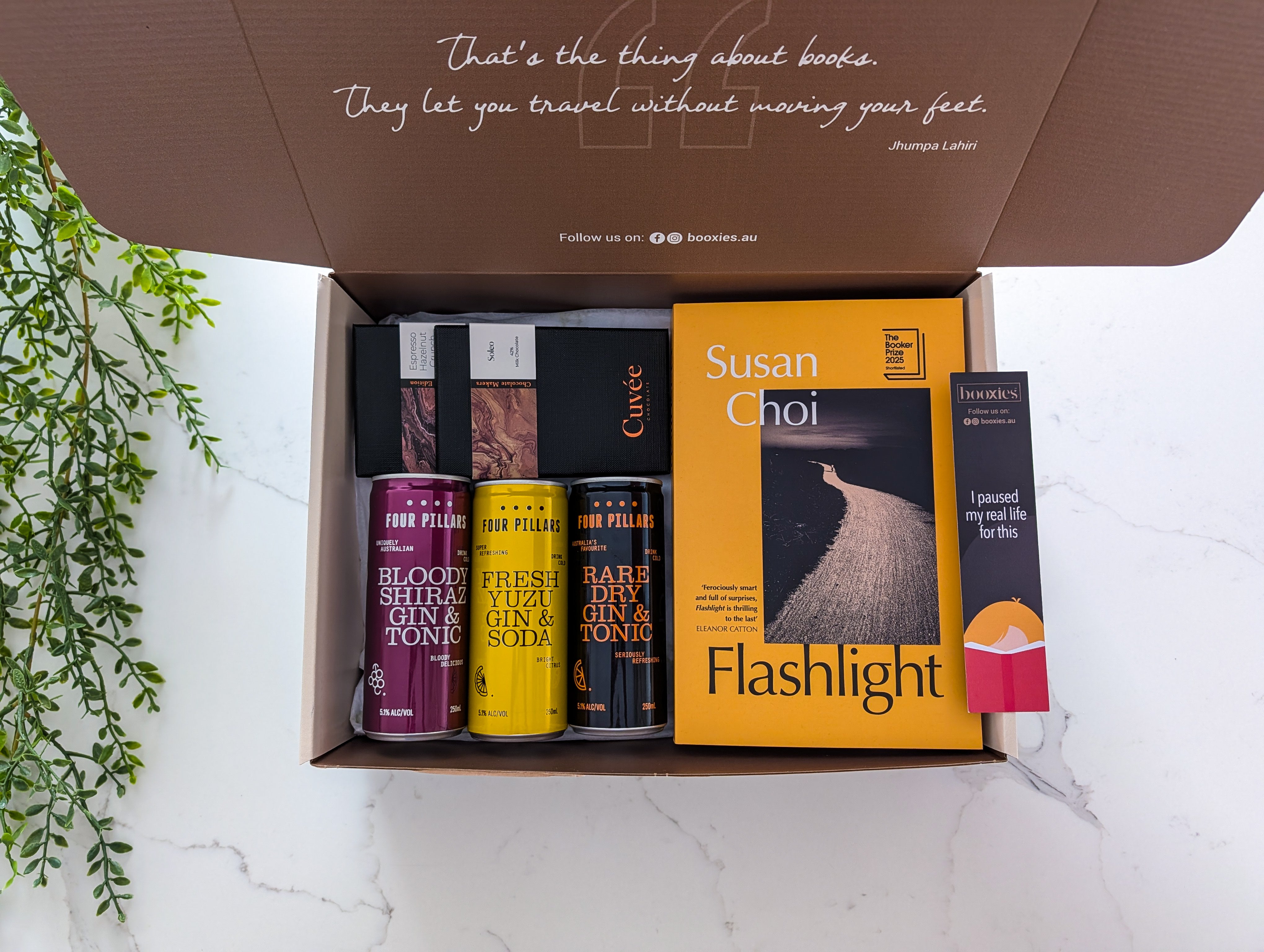 Box containing books with a quote on the lid, featuring 'Flashlight' by Susan Choi.