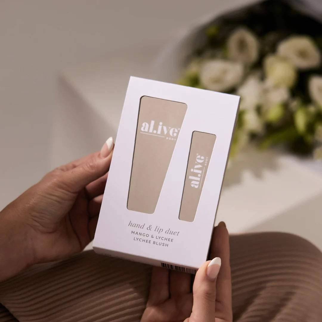 hands holding al.ive hand and ip duet - mango & lychee blush