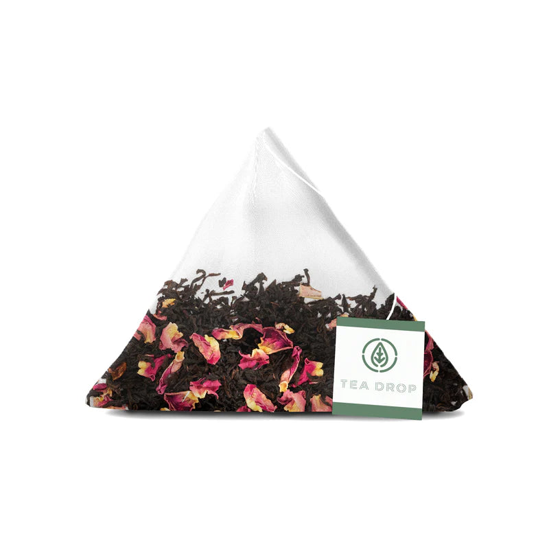Triangular tea bag with floral and leaf pattern on a white background