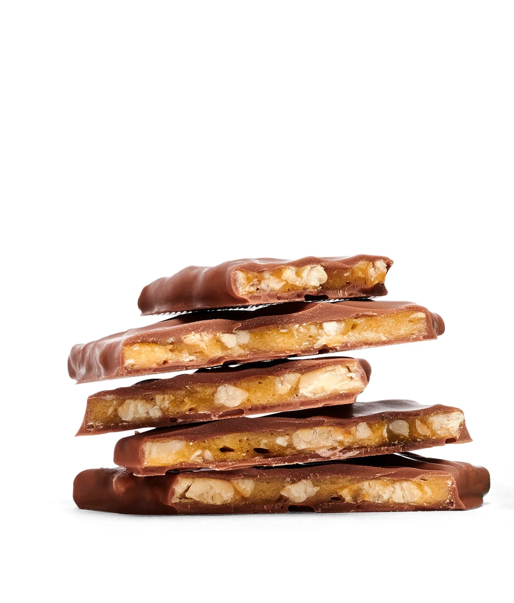 Stack of chocolate-covered candy bars with nuts on a white background
