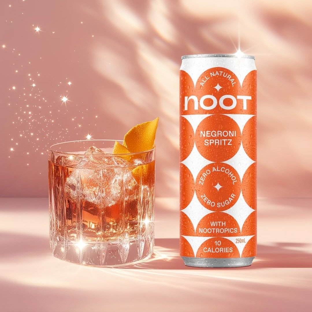 Noot can of Negroni Spritz with a glass of cocktail on a pink background
